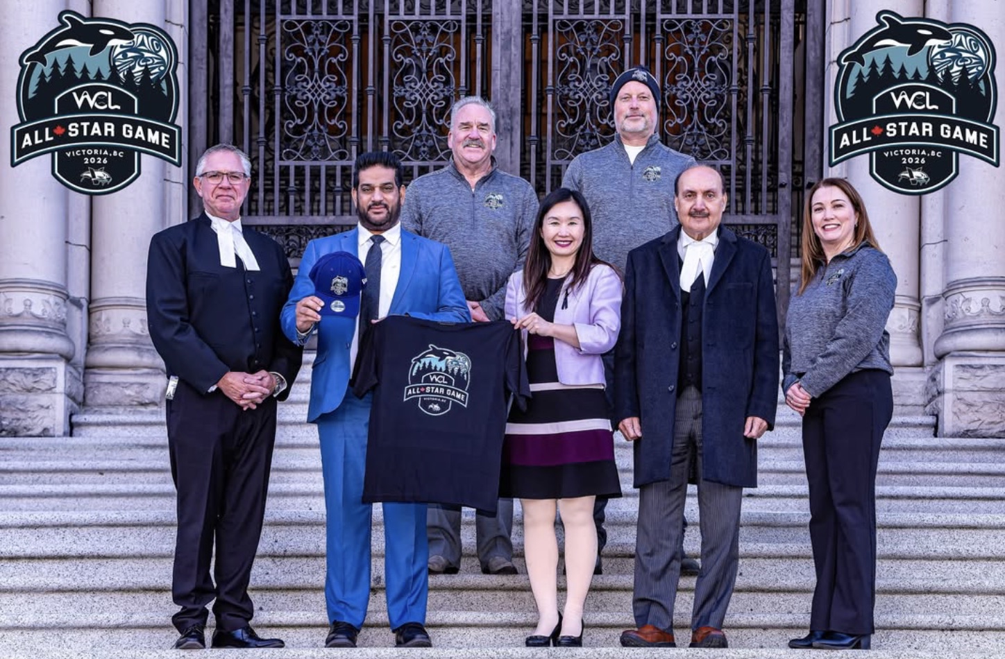 Mandeep Dhaliwal in a blue suit with a group holding a WCL All-Star Game shirt.